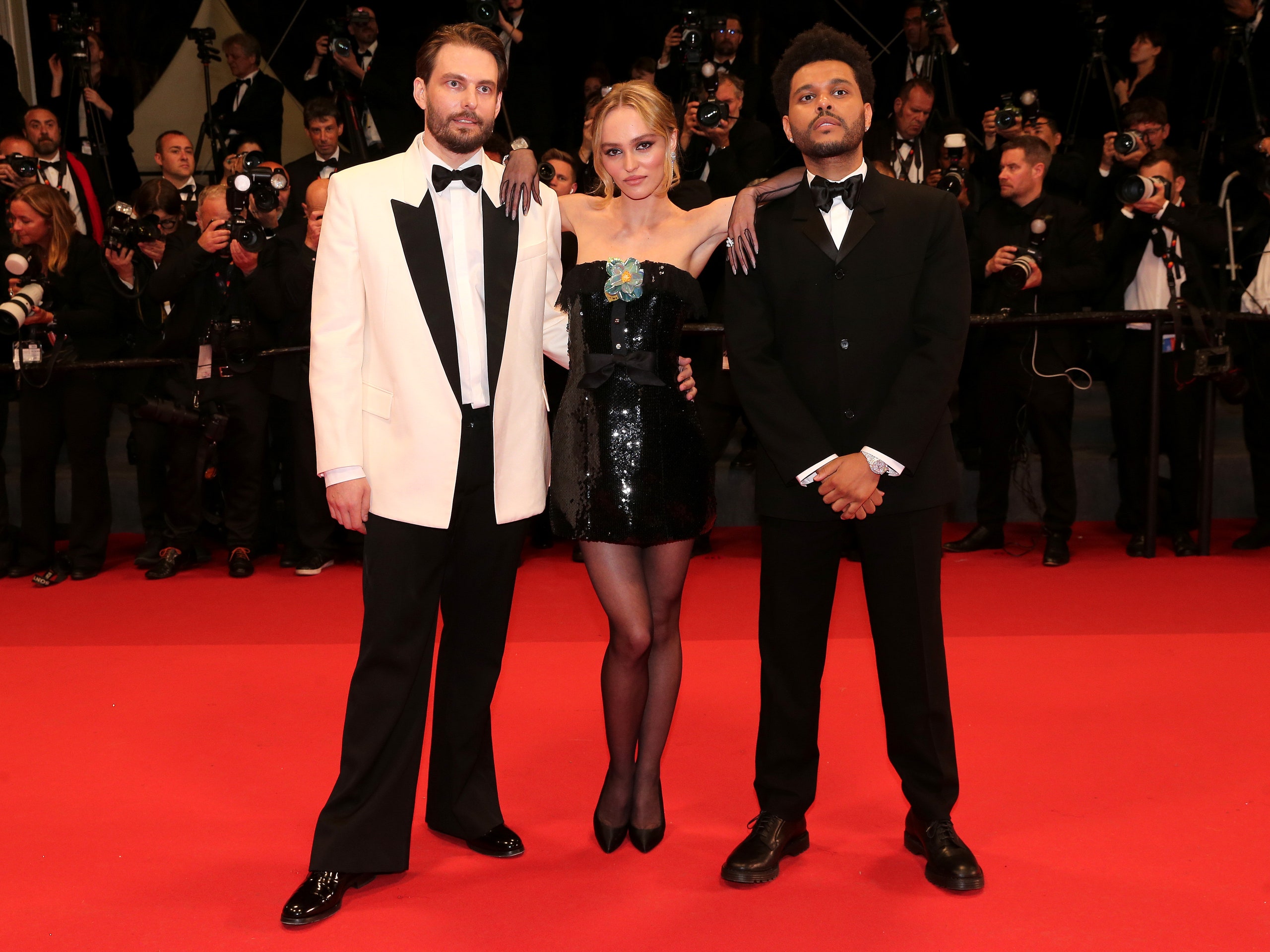 CANNES FRANCE  MAY 22  Sam Levinson LilyRose Depp and Abel â€œThe Weekndâ€ Tesfaye attend the The Idol red carpet during...
